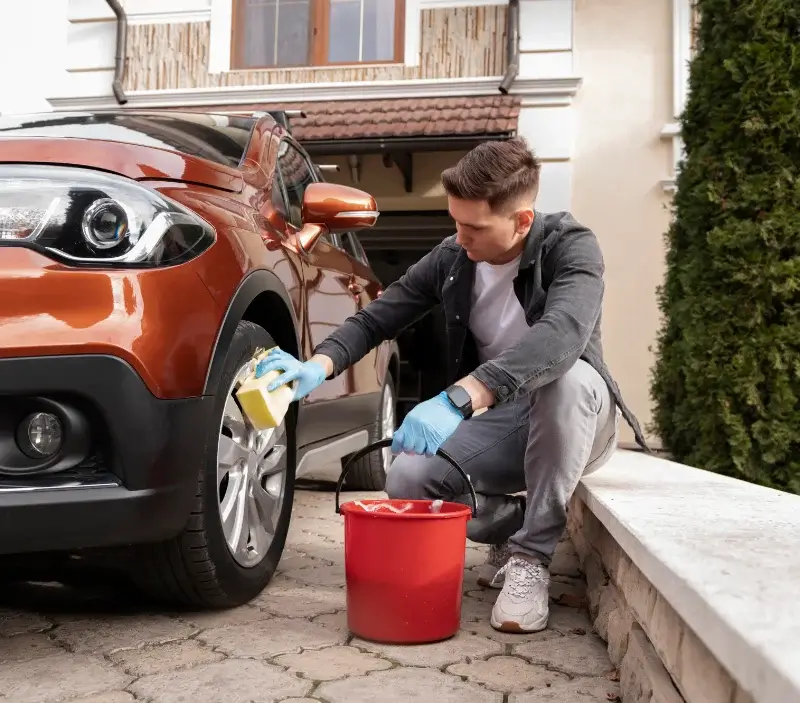 Lavage auto à domicile Neuvy-au-Houlme : professionnel intervenant sur un véhicule